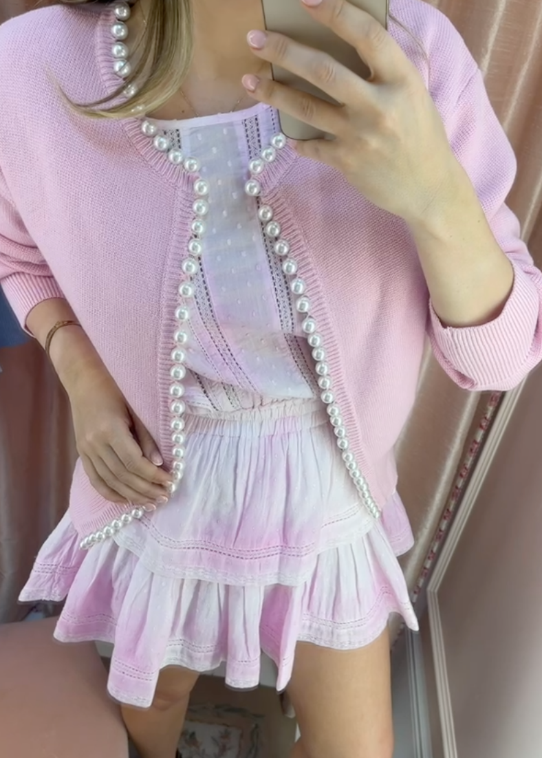 Self-Same handmade pink pearl cardigan in 100% organic cotton styled over a LoveShackFancy Natasha dress, photographed inside the LoveShackFancy Notting Hill UK 